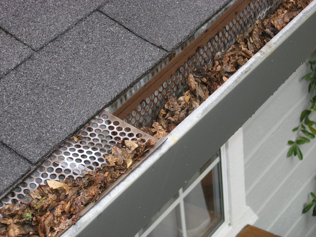 An image of a gutter guard filled with dead leaves